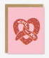 Greeting card with a heart-shaped pretzel design and 'Love from NYC' text on a pink background.