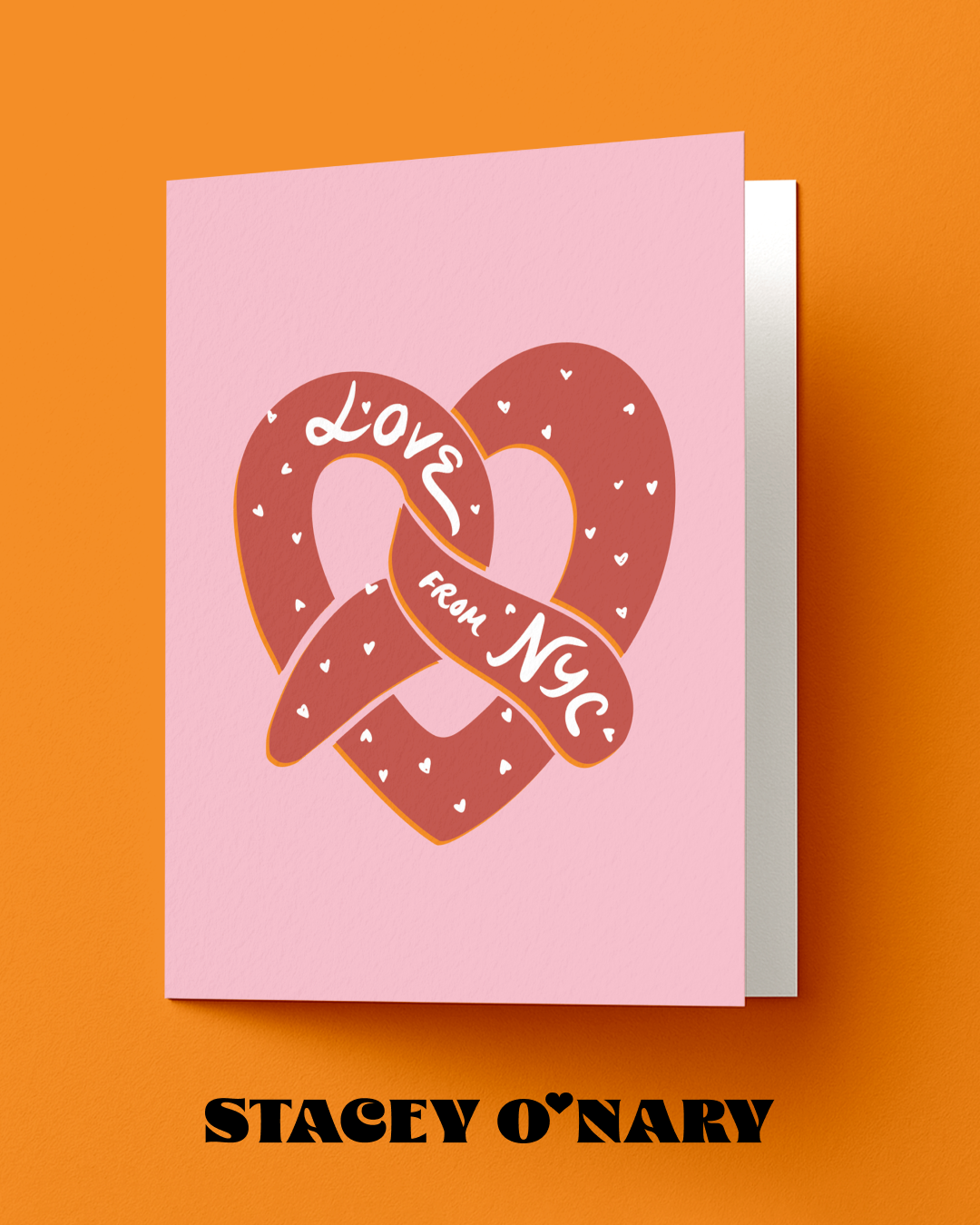 Greeting card with pretzel design and 'Love from NYC' text on a pink background, with 'Stacey O'Nary' branding.