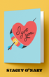 Greeting card with heart and arrow design on a yellow background, featuring the brand 'Stacey O'Nary'.