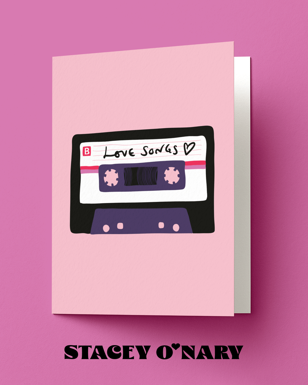 Card with a cassette tape design labeled 'Love Songs' on a pink background, featuring the brand 'Stacey O'Nary'.