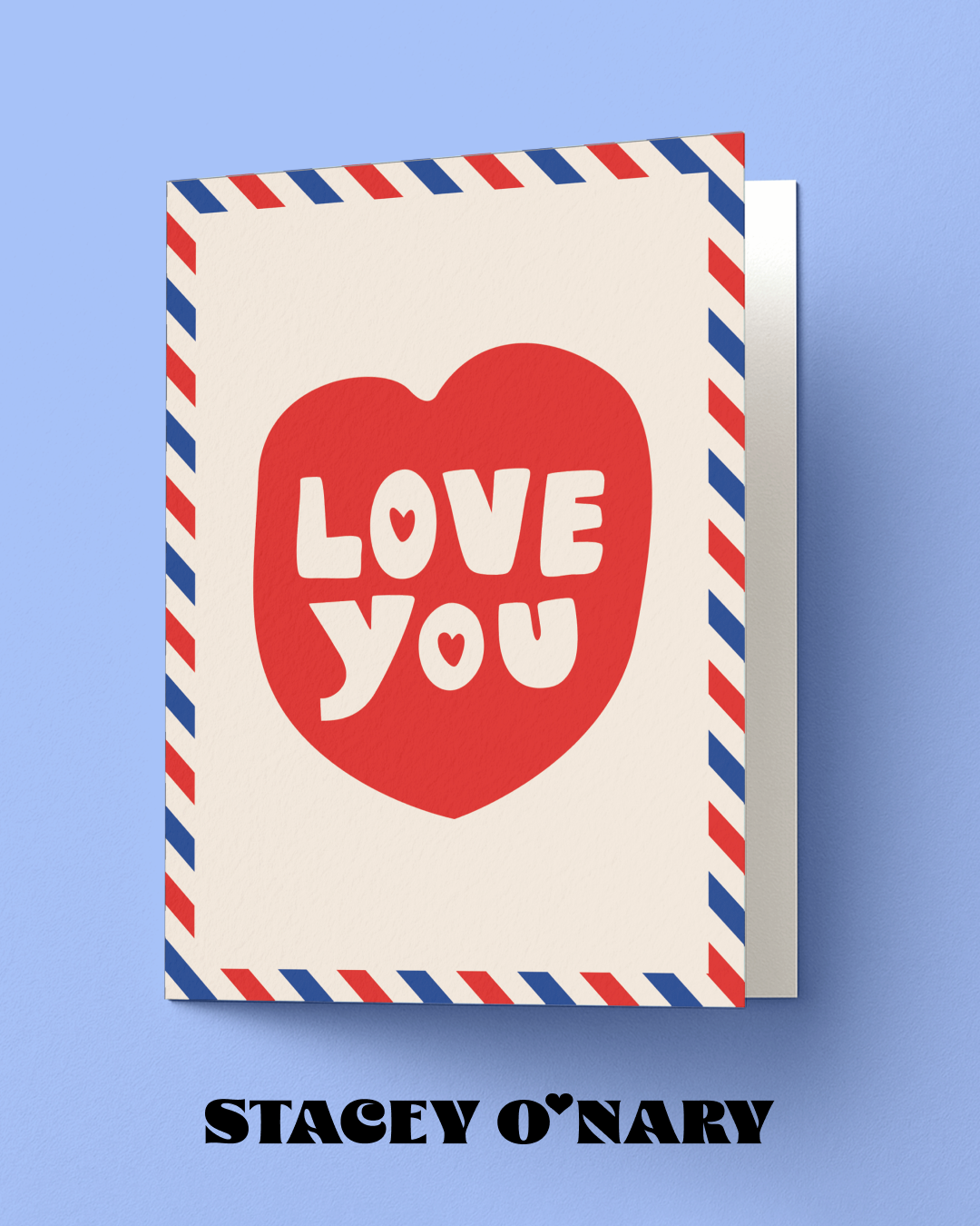 Greeting card with red heart and 'LOVE YOU' text on a blue background, featuring the brand 'Stacey O'Nary'.